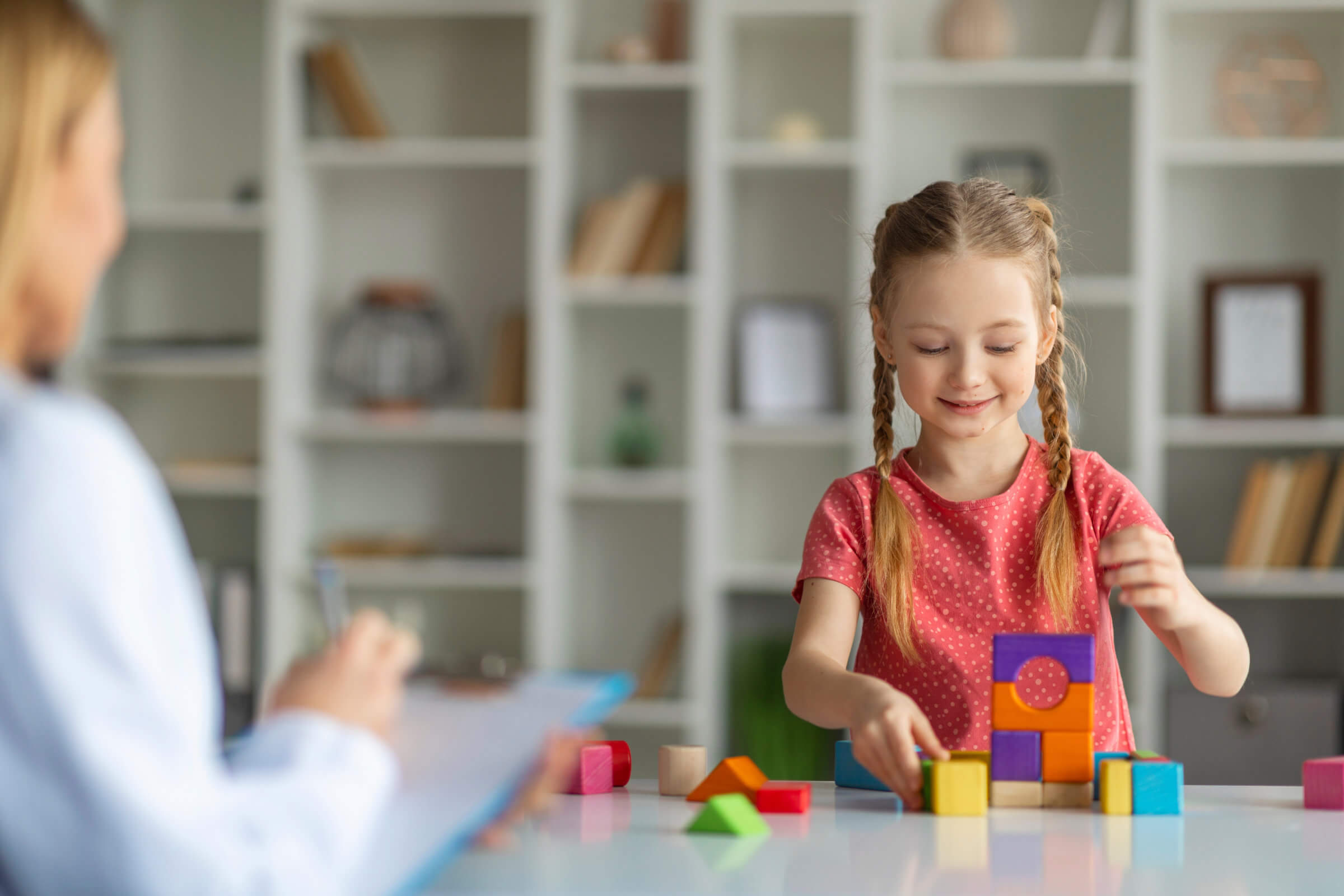 Child stacking blocks in classroom